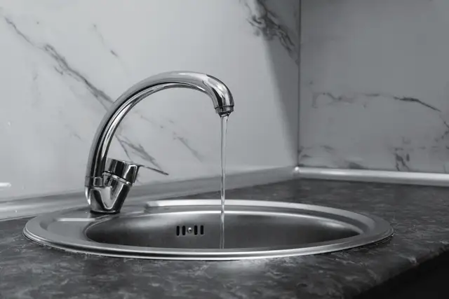 Chrome kitchen faucet over a stainless sink