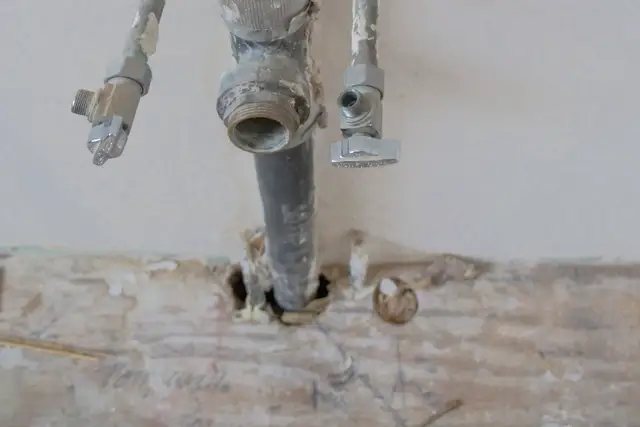 Old galvanized supply pipes coming out of a wall