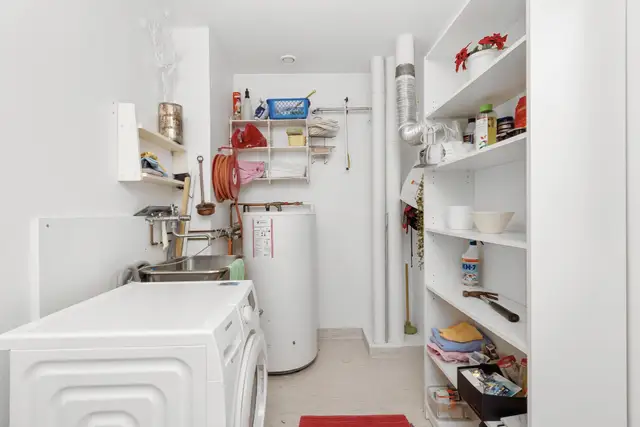 Tank water heater in a laundry room