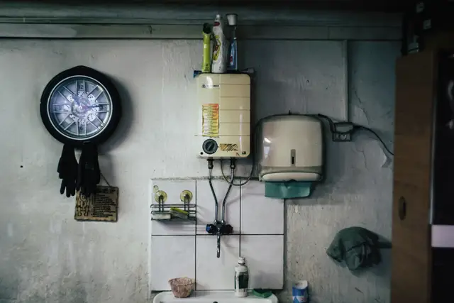 Wall-mounted water heater above a utility sink