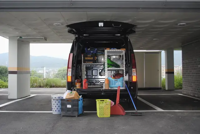 An open work van stocked with tools and equipment
